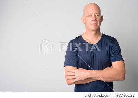 Portrait of mature handsome bald man with arms crossed Portrait of mature handsome bald man with arms crossed 58786122