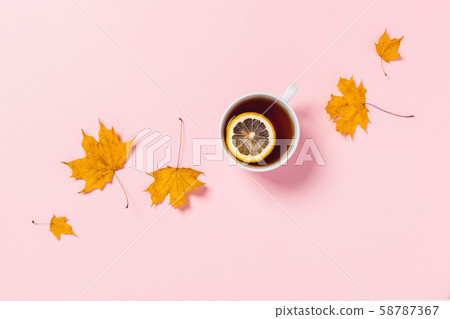 Cozy autumn composition. Tea cup with slice of lemon and maple leaves. Cozy autumn composition. Tea cup with slice of lemon and maple leaves. 58787367