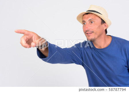 Happy mature tourist man pointing finger ready for vacation Happy mature tourist man pointing finger ready for vacation 58787794
