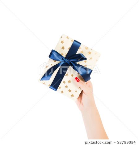 Woman hands give wrapped Christmas or other 58789084