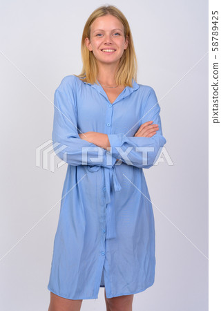 Portrait of young happy woman smiling with arms crossed Portrait of young happy woman smiling with arms crossed 58789425