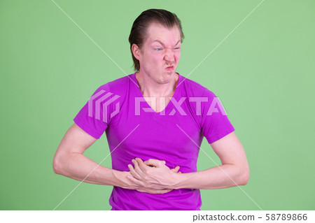 Portrait of stressed young man having stomachache 58789866