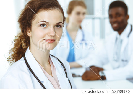 Happy doctor woman with medical staff at the hospital. Multi ethnic people group 58789920