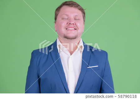 Face of happy overweight bearded businessman relaxing with eyes closed 58790118