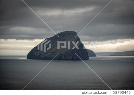 Islet under cloudy sky in Faroe Islands Islet under cloudy sky in Faroe Islands 58790445