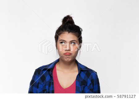 Asian girl with funny boring face over background. Asian girl with funny boring face over background. 58791127