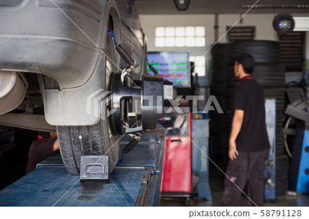 Car tyre alignment wheel balance at garage service Car tyre alignment wheel balance at garage service 58791128