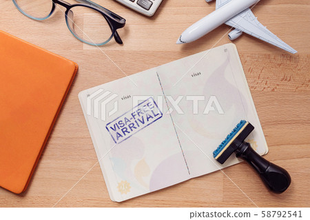 visa free arrival stamp on foreign passport with airplane model. oversea travel in visa free arrival country concept 58792541