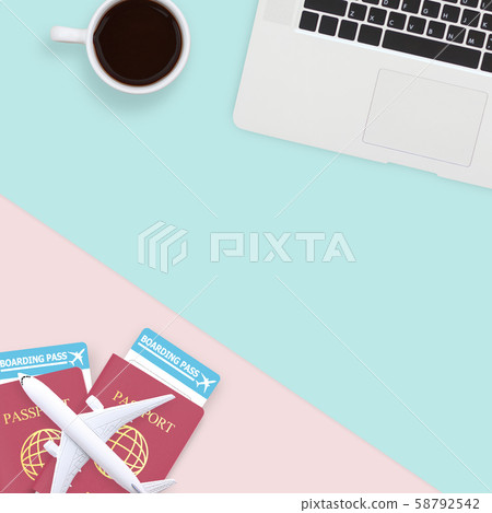 flat lay of passport , white plane model and computer laptop on pastel blue and pink color background with copy space. travel , visa and vacation concept 58792542