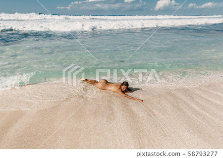 Young Woman without Bra on the Tropical Beach of Bali Island