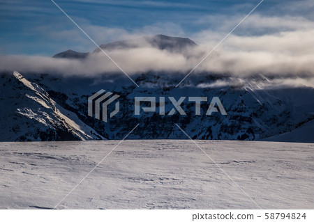 Mountains rising from the clouds before sunset 58794824