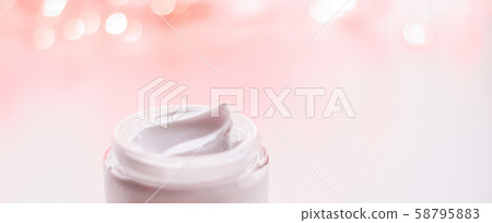 Facial cream moisturizer jar on holiday glitter 58795883