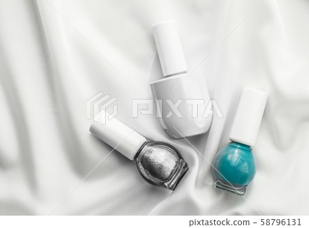 Nail polish bottles on silk background, french Nail polish bottles on silk background, french 58796131
