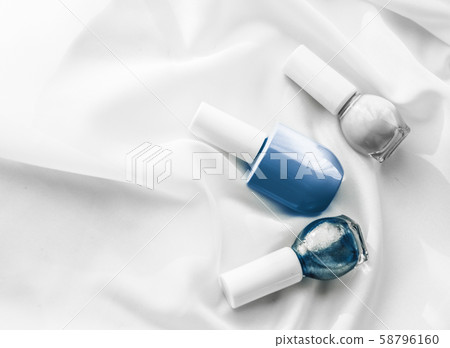 Nail polish bottles on silk background, french 58796160