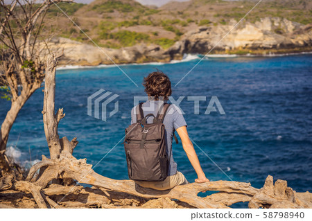 Man traveler against the background of the sea Angel's Billabong in Nusa Penida, Bali, Indonesia 58798940