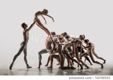The group of modern ballet dancers. Contemporary art ballet. Young flexible athletic men and women. The group of modern ballet dancers. Contemporary art ballet. Young flexible athletic men and women. 58799505