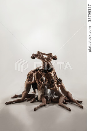 The group of modern ballet dancers. Contemporary art ballet. Young flexible athletic men and women. The group of modern ballet dancers. Contemporary art ballet. Young flexible athletic men and women. 58799537