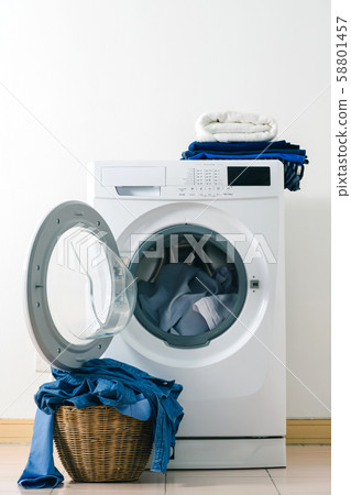 Close up washing machine and clothes in basket on 58801457
