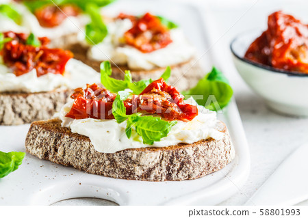 Sandwiches with cottage cheese and sun-dried tomato Sandwiches with cottage cheese and sun-dried tomato 58801993
