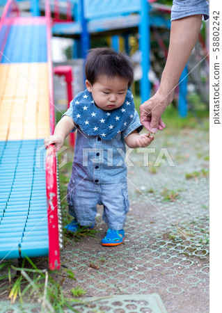Infants playing in the park 58802242