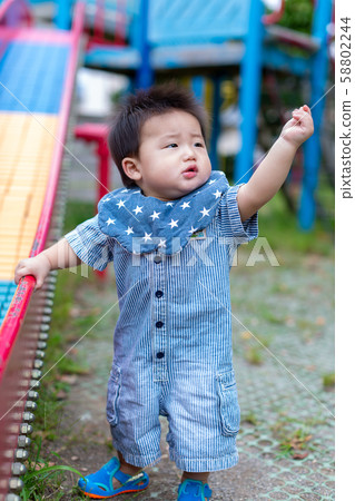 Infants playing in the park 58802244