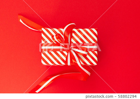Background with red and white striped gift box Background with red and white striped gift box 58802294