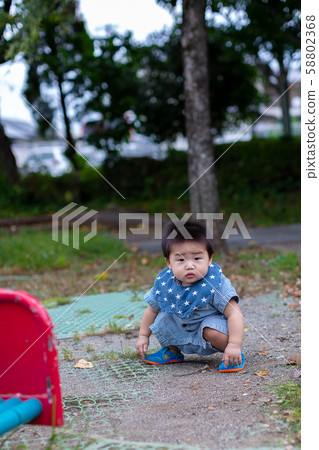 Infants playing in the park 58802368