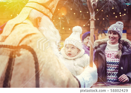 St Nikolaus and an extended family on the Christmas market St Nikolaus and an extended family on the Christmas market 58802429