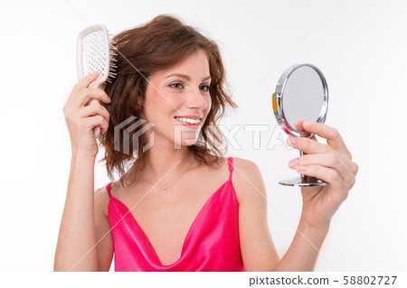 Young beautiful girl with wavy brown hair, clean skin, flat teeth, beautiful smile, in pink jersey 58802727