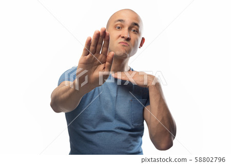 Photo of young shaved man on white telling no Photo of young shaved man on white telling no 58802796