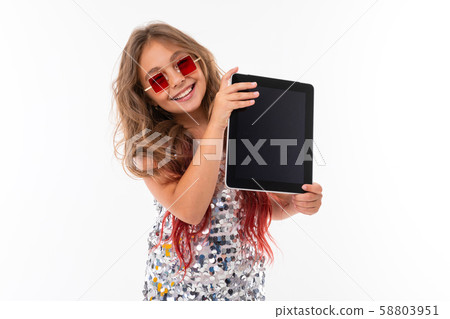 Teen girl with long blonde hair dyed with tips pink, in shiny light dress, black and white sneakers 58803951
