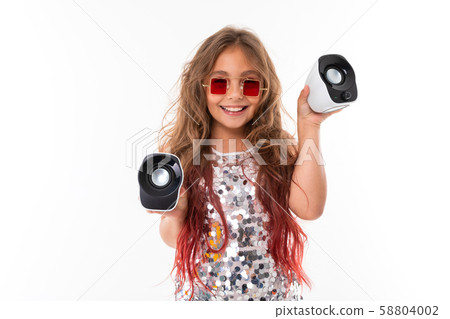 Teen girl with long blonde hair dyed with tips pink, in shiny light dress, black and white sneakers Teen girl with long blonde hair dyed with tips pink, in shiny light dress, black and white sneakers 58804002