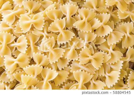some farfalle pasta forming a background pattern 58804545