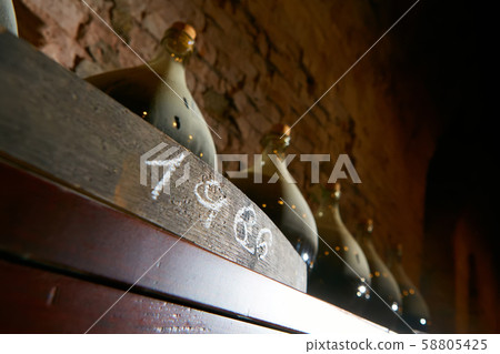 Vintage wine bottles in cellar. Shallow dof. 58805425