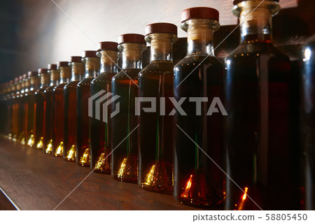 Colour scale gradation of whiskey and cognac infusion in bottles. bottle ranking by age time. Colour scale gradation of whiskey and cognac infusion in bottles. bottle ranking by age time. 58805450