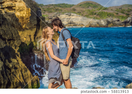Man and woman tourists in the honeymoon against the background of the sea Angel's Billabong in Nusa Man and woman tourists in the honeymoon against the background of the sea Angel's Billabong in Nusa 58813913