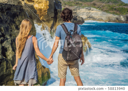 Man and woman tourists in the honeymoon against the background of the sea Angel's Billabong in Nusa Man and woman tourists in the honeymoon against the background of the sea Angel's Billabong in Nusa 58813940