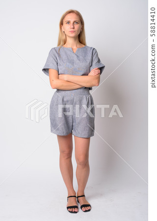 Full body shot of young beautiful blonde woman with arms crossed 58814410