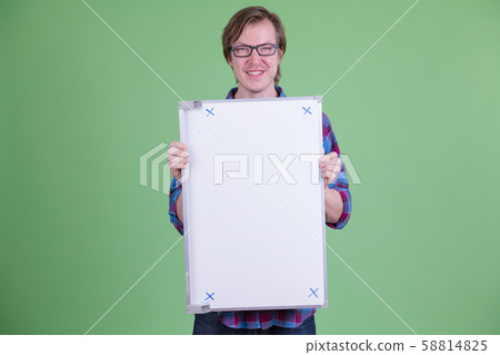 Happy young handsome hipster man with eyeglasses holding white board 58814825