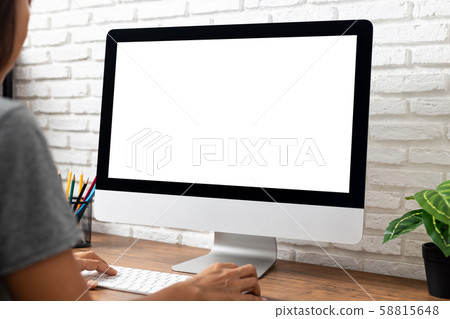 woman working empty screen computer on wood desk in home office woman working empty screen computer on wood desk in home office 58815648