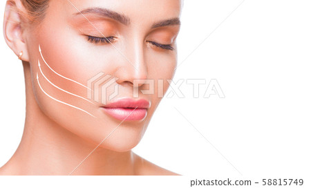 Portrait of attractive woman with arrows on her face over white background. Face lifting concept. Portrait of attractive woman with arrows on her face over white background. Face lifting concept. 58815749