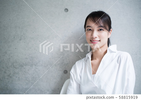A young woman sitting on a chair 58815919