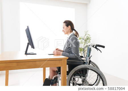 Foreign woman working in wheelchair Foreign woman working in wheelchair 58817004