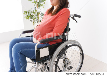 Pregnant woman in wheelchair 58818531