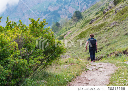 Back view male hiker walks in beautiful mountains in North Caucasus 58818666