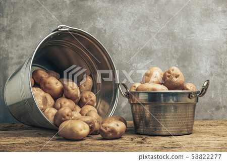 Fresh potatoes in silver basket on a old oak 58822277