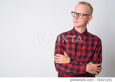 Portrait of young blonde hipster man thinking with arms crossed 58823261