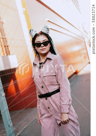 Portrait of beautiful cool girl over urban wall. Sunny day. Girl in sunglasses 58823714