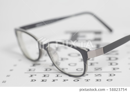 Eyeglasses on eyesight test chart background. 58823754
