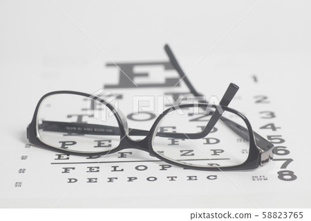 Eyeglasses on eyesight test chart background. 58823765